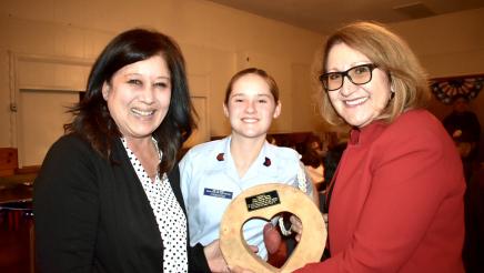 Troop 76 Girl Scout and her troop leader present Majority Leader Reyes with an award.