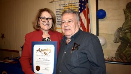 Majority Leader Reyes poses with one of her honorees. The honoree is holding their Veteran of Distinction certificate