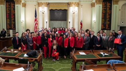 Group photo of legislators wearing red.