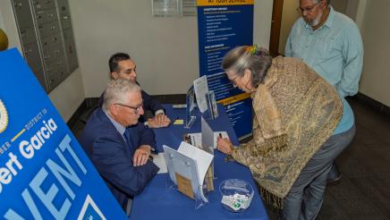 Constituents check in at sign-in table
