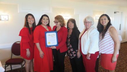 Assemblymember Reyes taking a picture with guests and their certificate