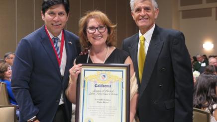 Assemblymember accepts an award at LULAC State Convention