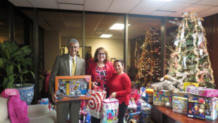 Holiday Open House Photo with Assemblymember Reyes and Constituents with toys