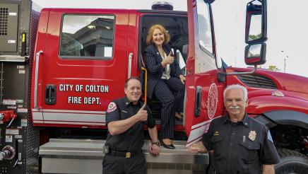 Reyes presenting Colton with a new fire engine